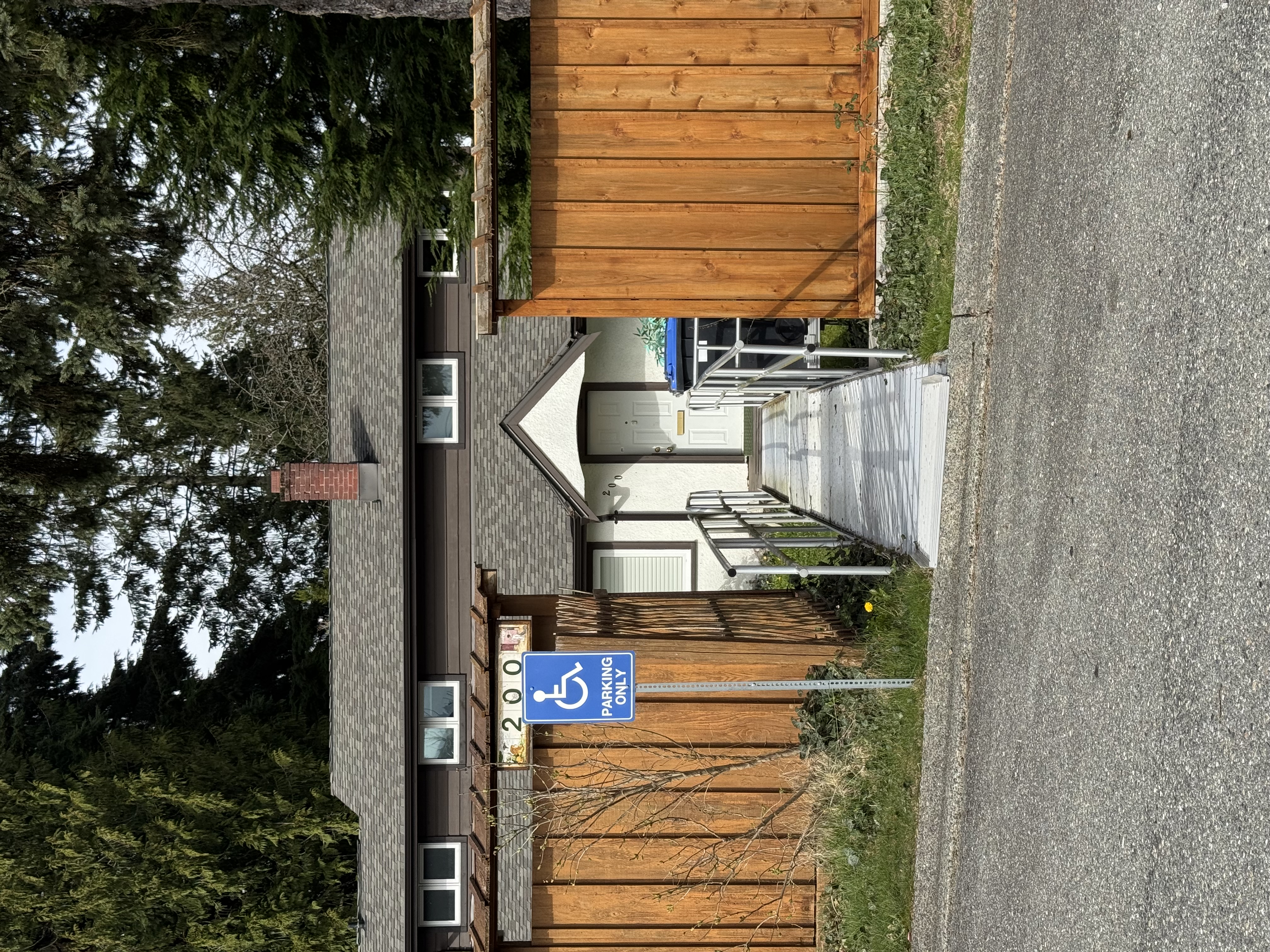 Home with accessibility ramp and wheelchair parking sign